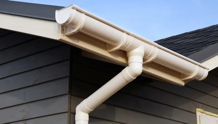 Professional downspout installation on residential home