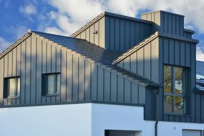 White energy-efficient standing seam metal roof on a modern home