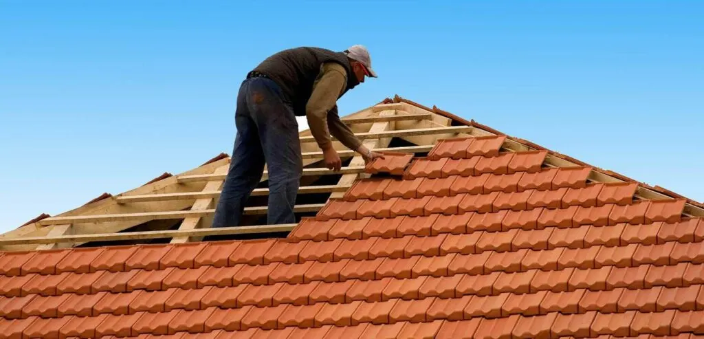 Metal roof repair contractor sealing a standing seam roof