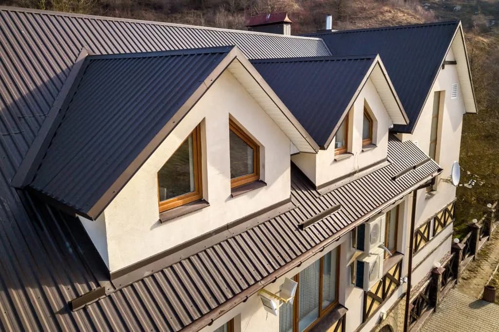 Standing seam metal roof under stormy sky