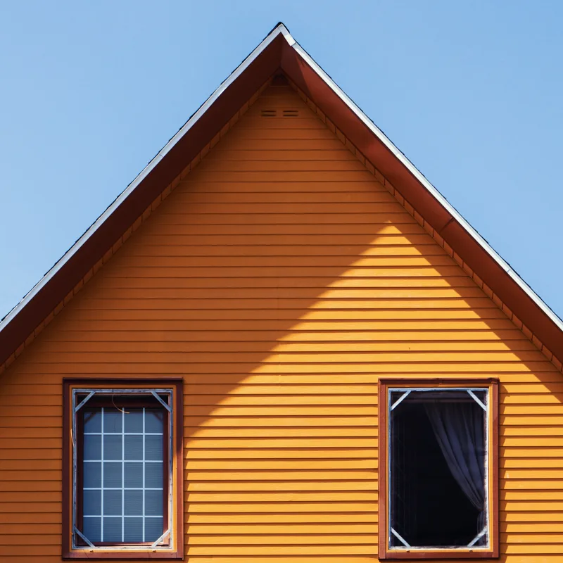 Vinyl siding installers working on a home